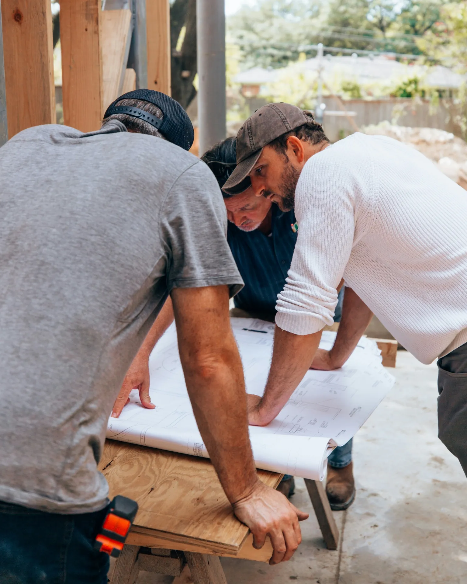 Burney Construction team reviewing project plans on site